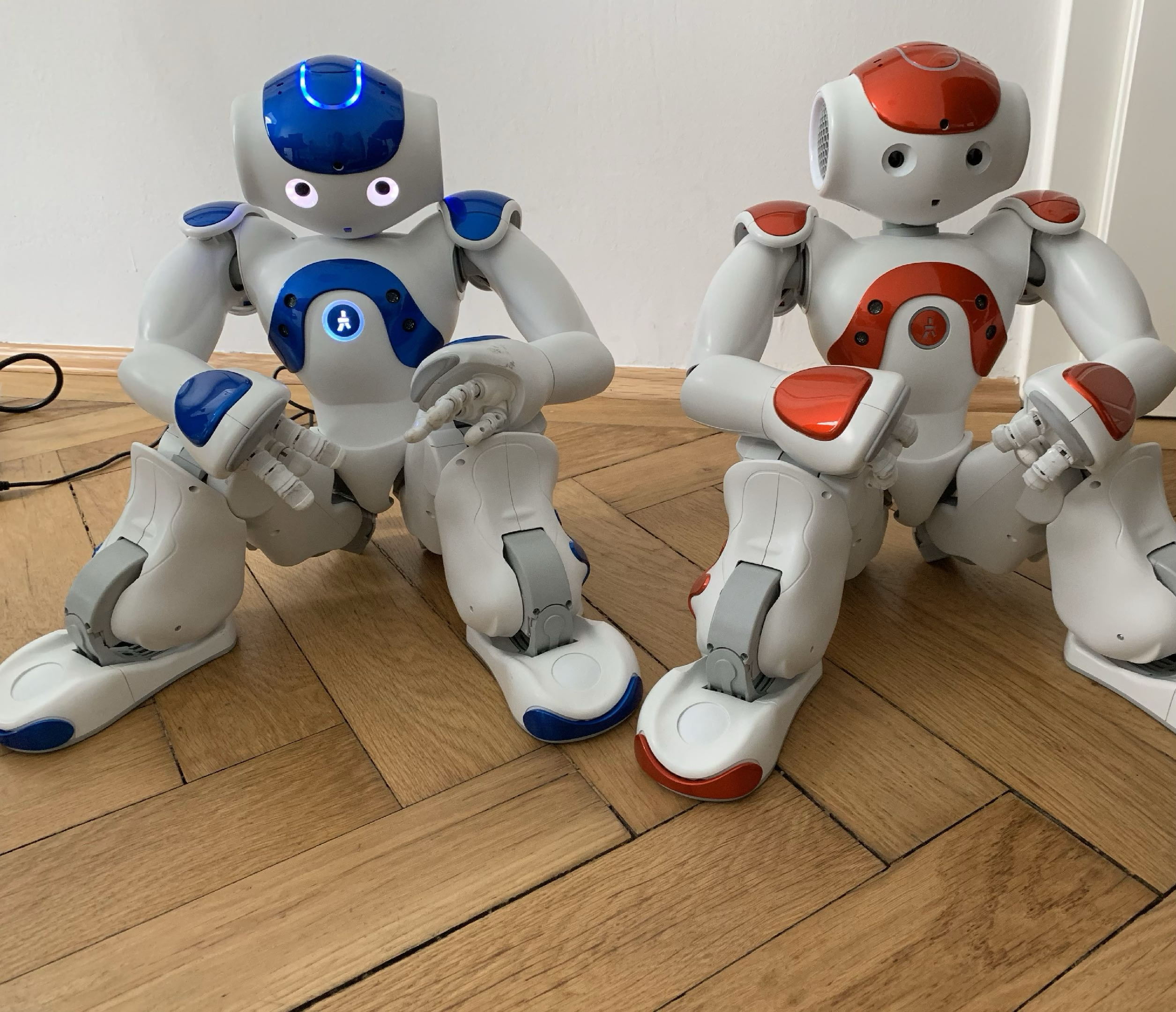 Nao robots sitting on floor
